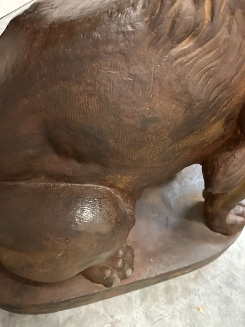 antique sculpture of two lions with fur detail