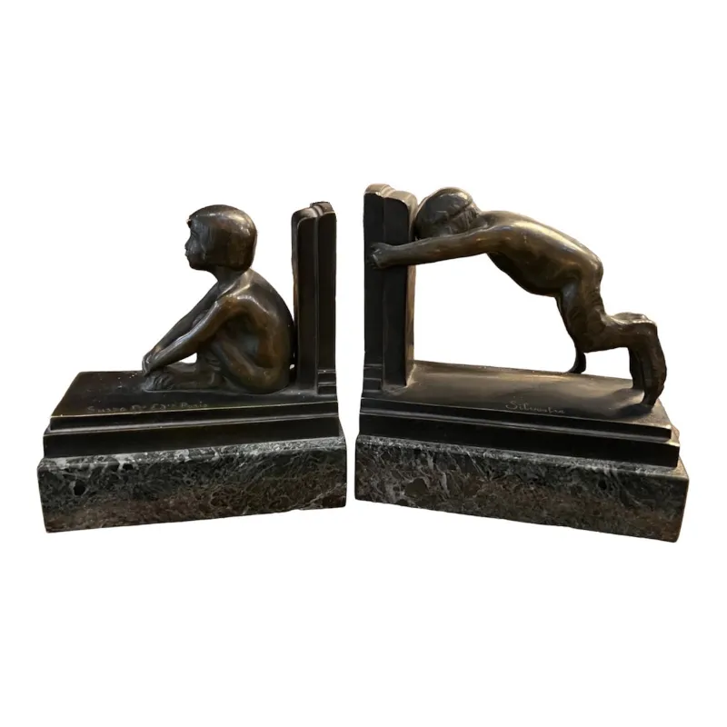 suportes para livros antigos em estilo art deco com figuras de crianças