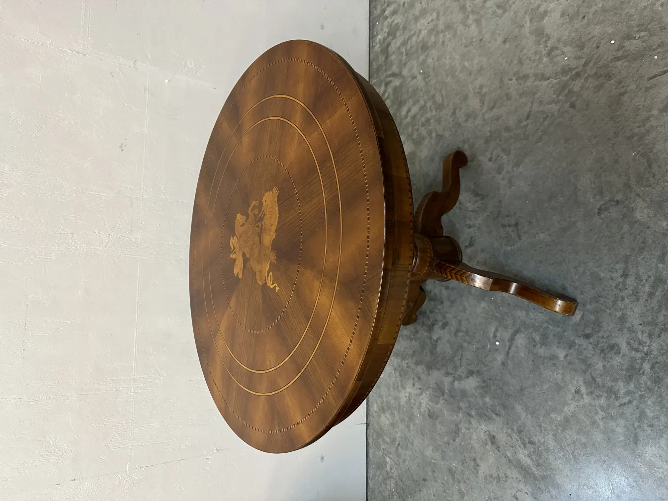 antique round table featuring a decorative design on top