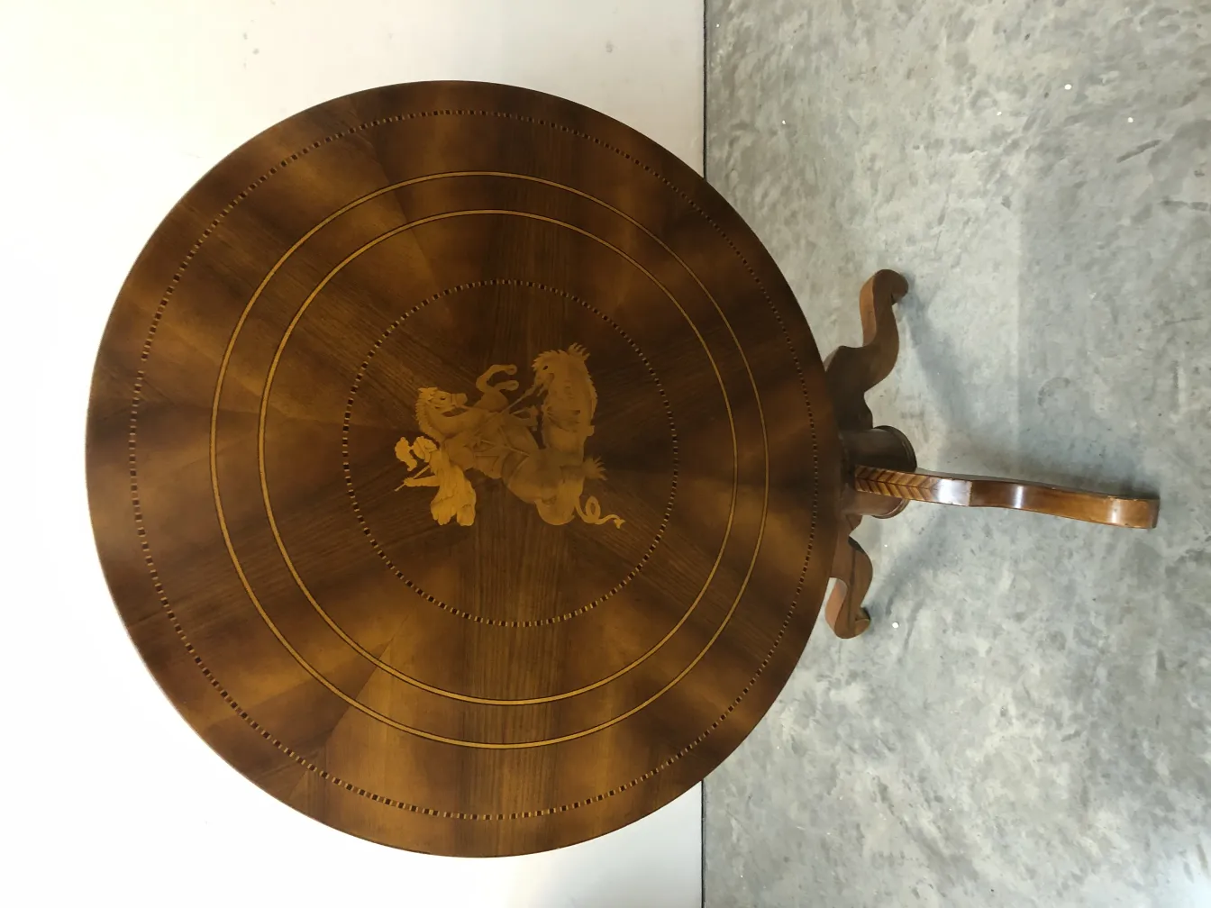 antique round table featuring an intricate design on top