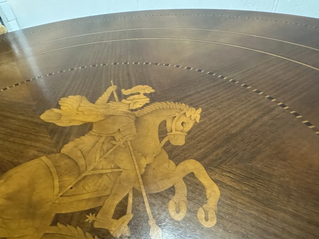 antique table featuring engraving of knight on horseback