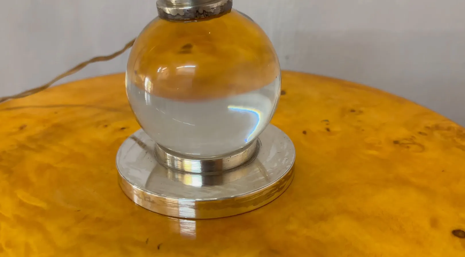 two antique table lamps on a wooden table