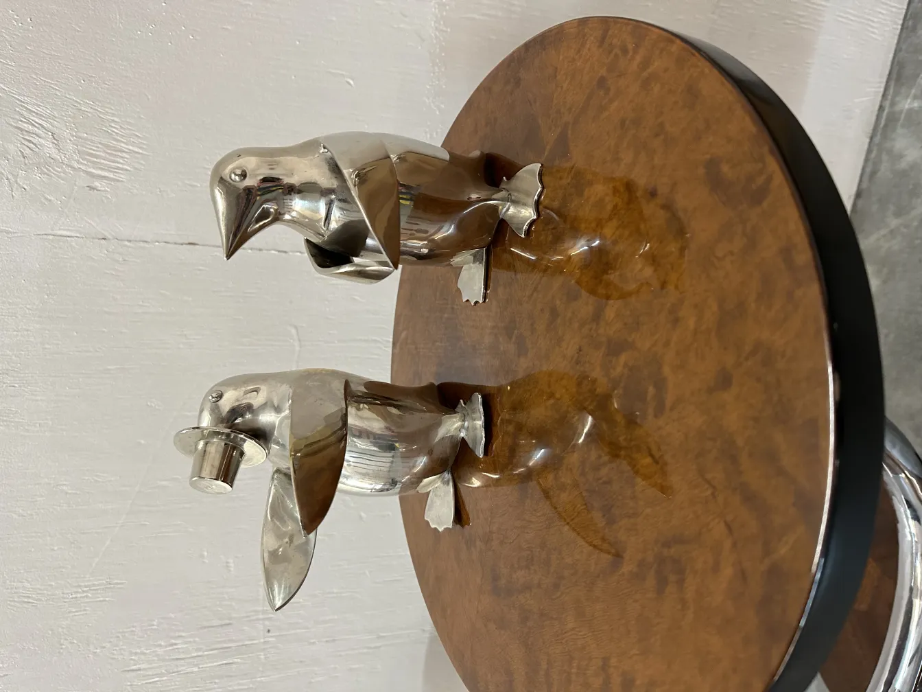 two antique-style penguins on a table