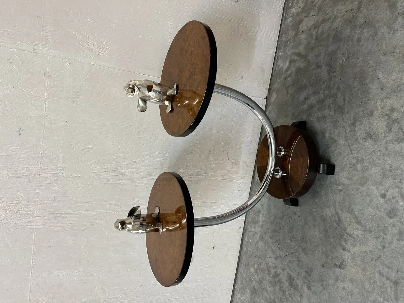 Two antique penguins adorning a stylish stand.