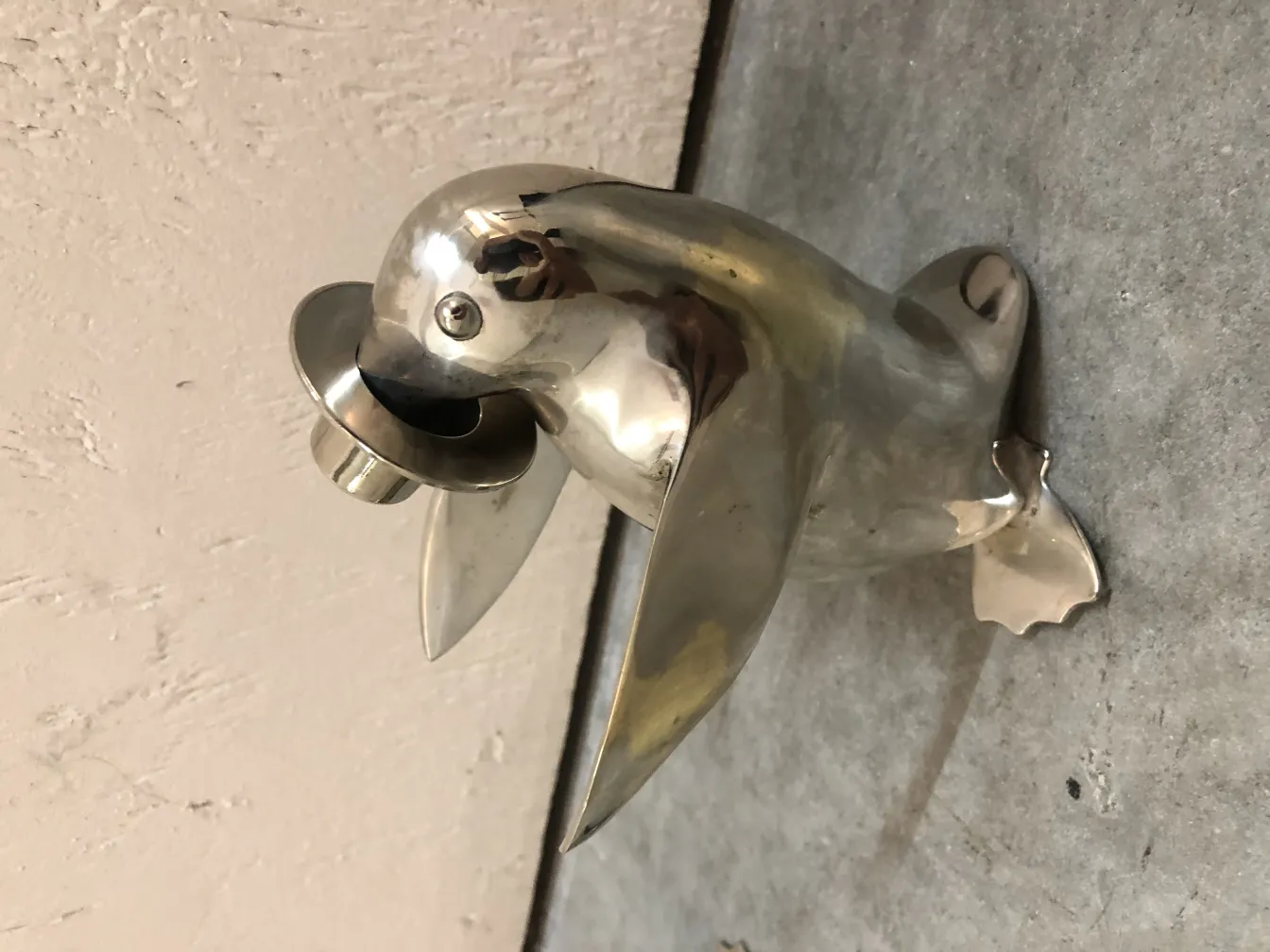 Antique sculpture of two stylized penguins.