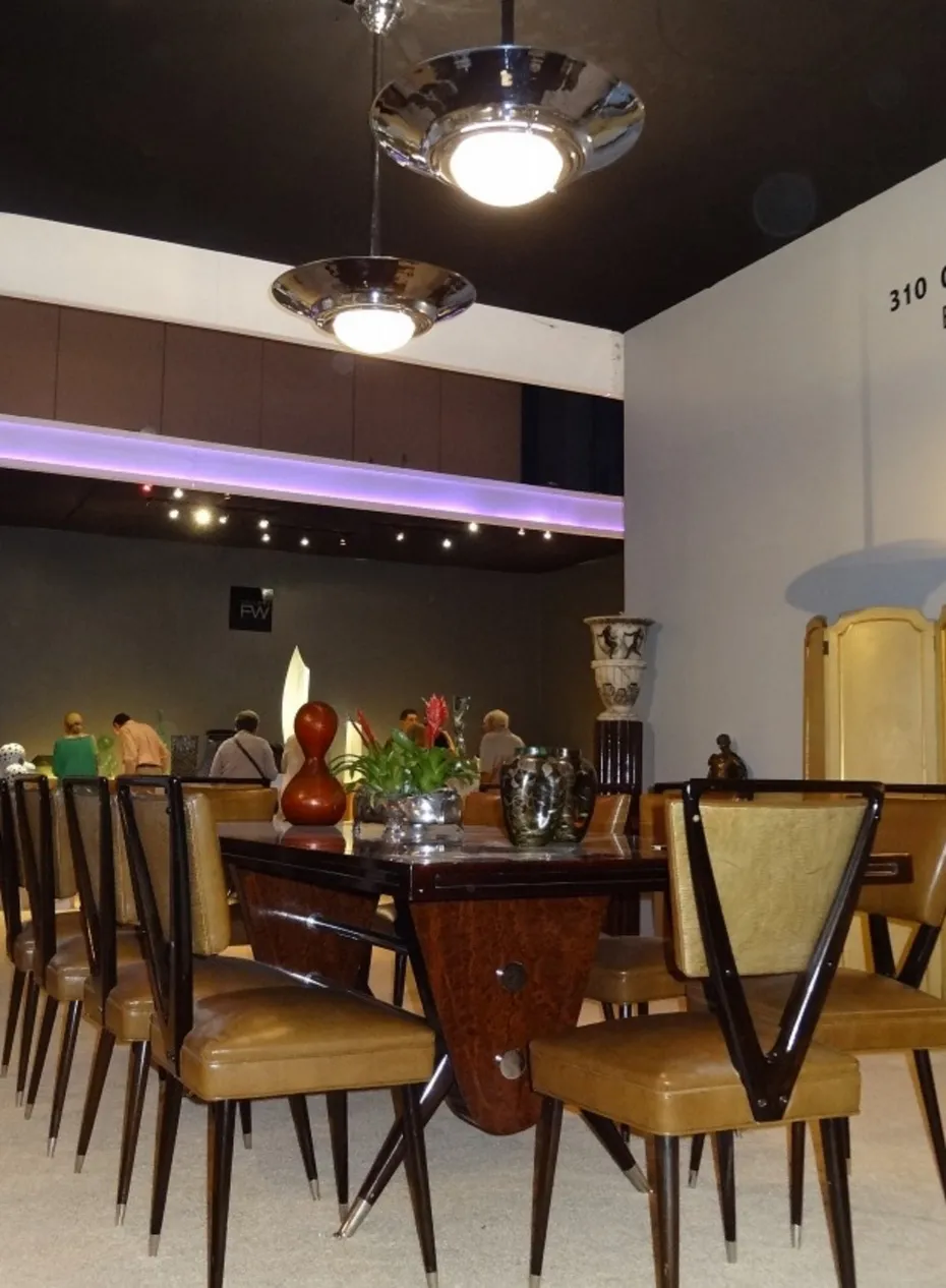 Antique dining table with chairs for ten people, decorated with flowers