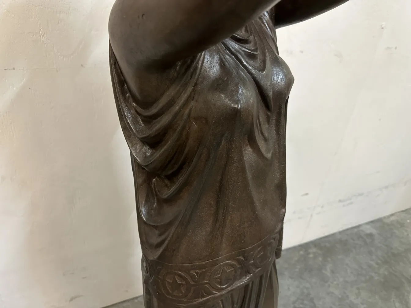 Antique sculpture from Val D'Osne showcasing fabric details.