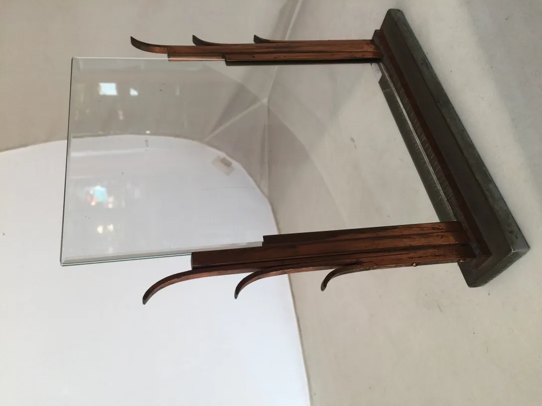 Antique picture frame with clear glass and elegant support.