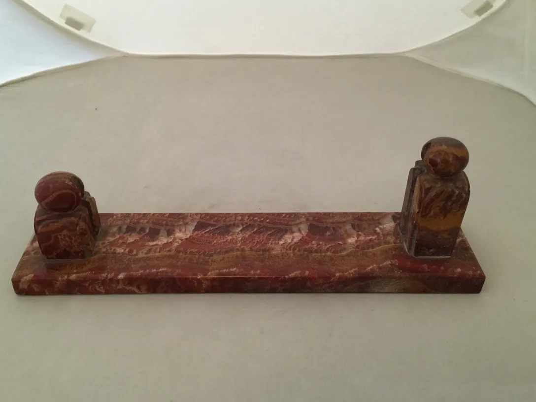 Antique picture frame with decorative details on the sides.