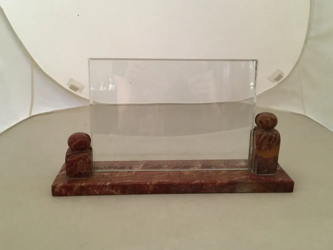 Antique picture frame with round decorative base, clear and color details.