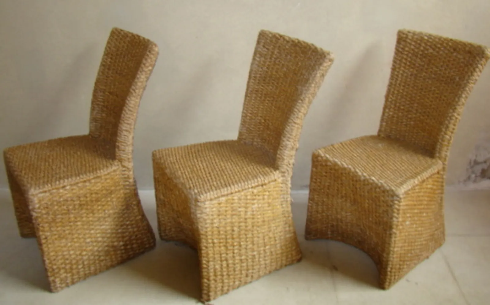 Simple antique dining table for 4 people with wicker seating.