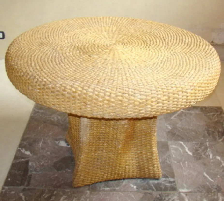 Antique dining table with round shape and structured base, suitable for four people.