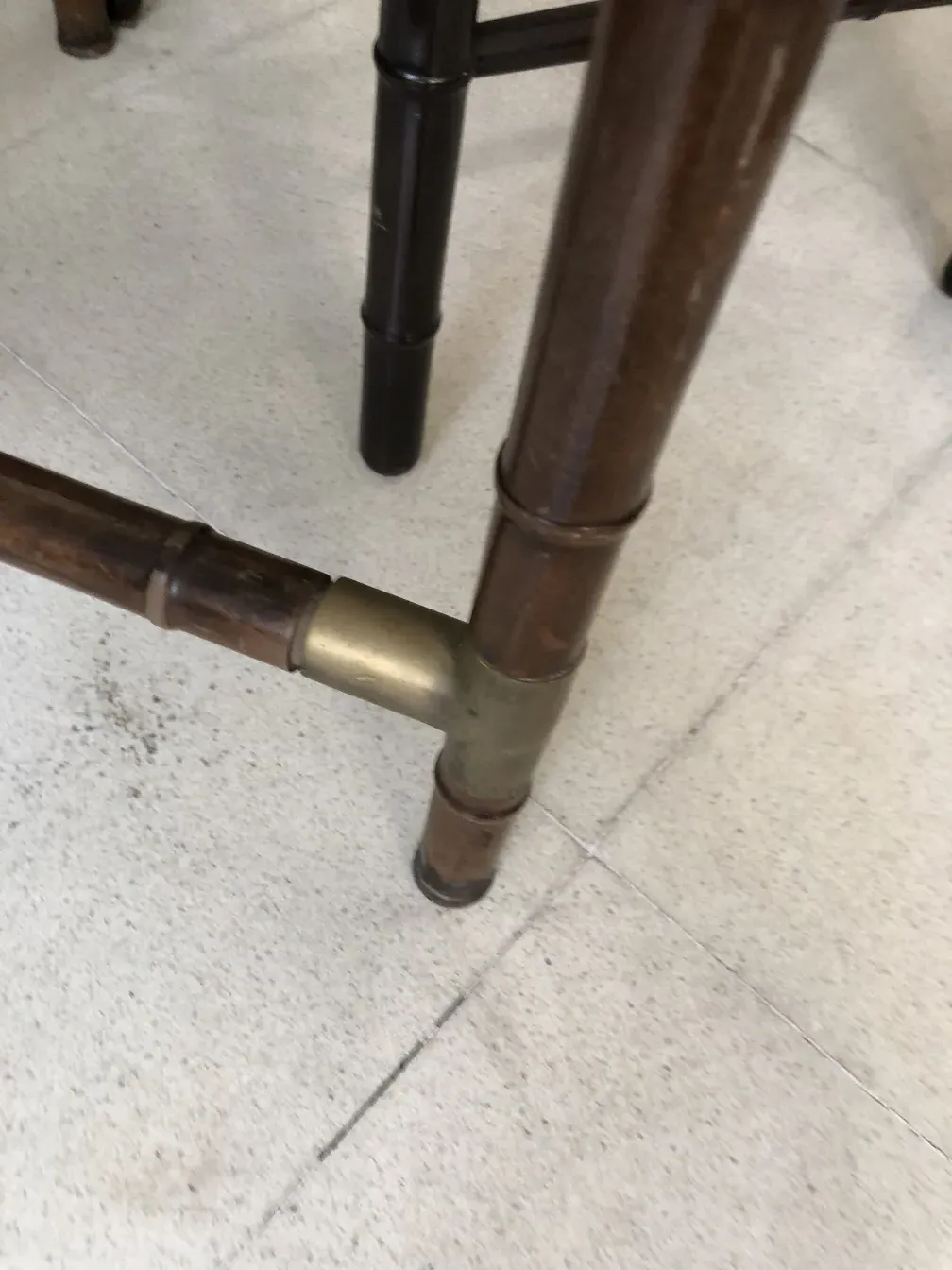 detail of an antique dining table for six people, with visible legs and supports