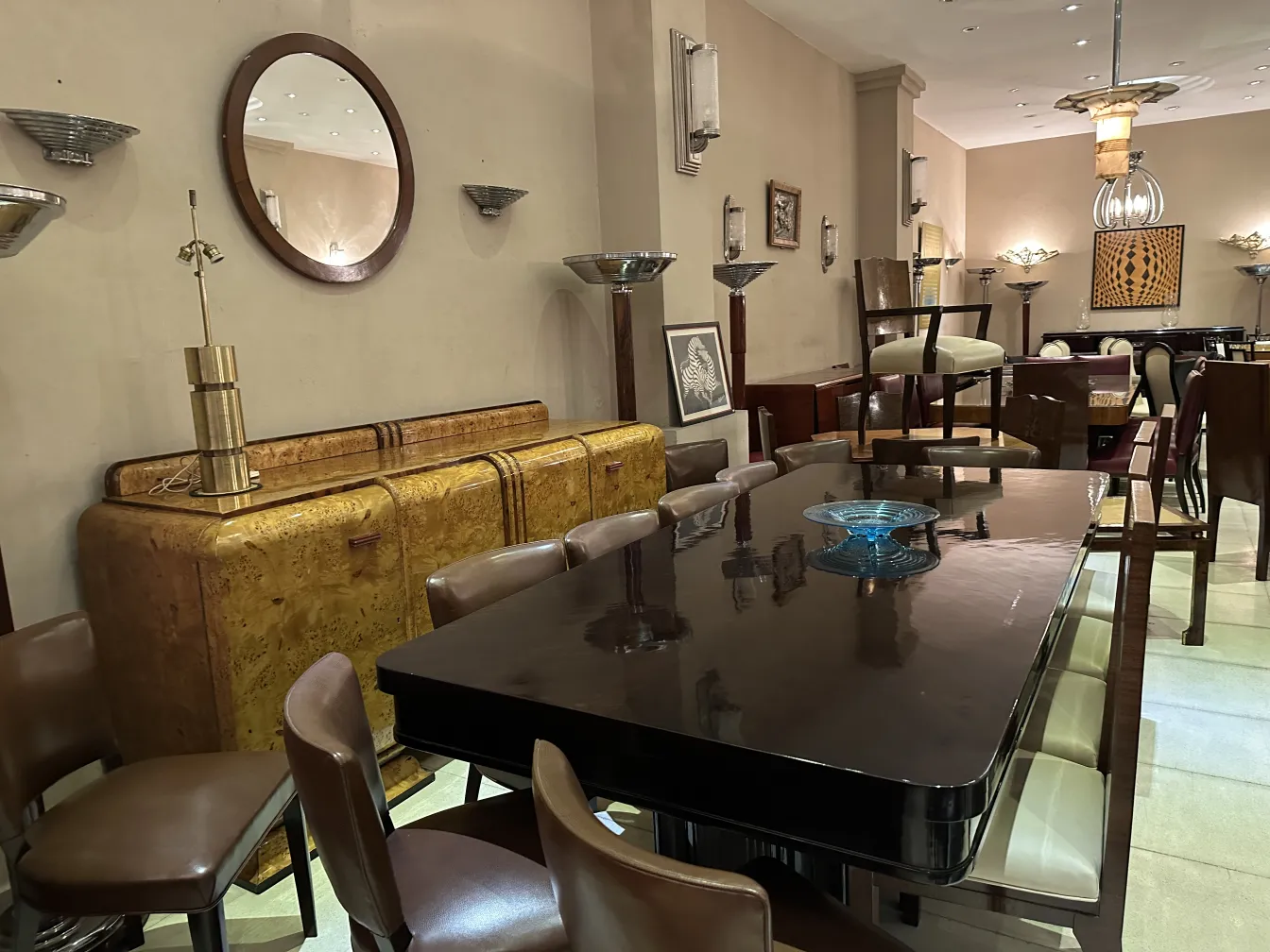 Antique dining table for 10 people, featuring elegant decor and chairs in a refined setting.