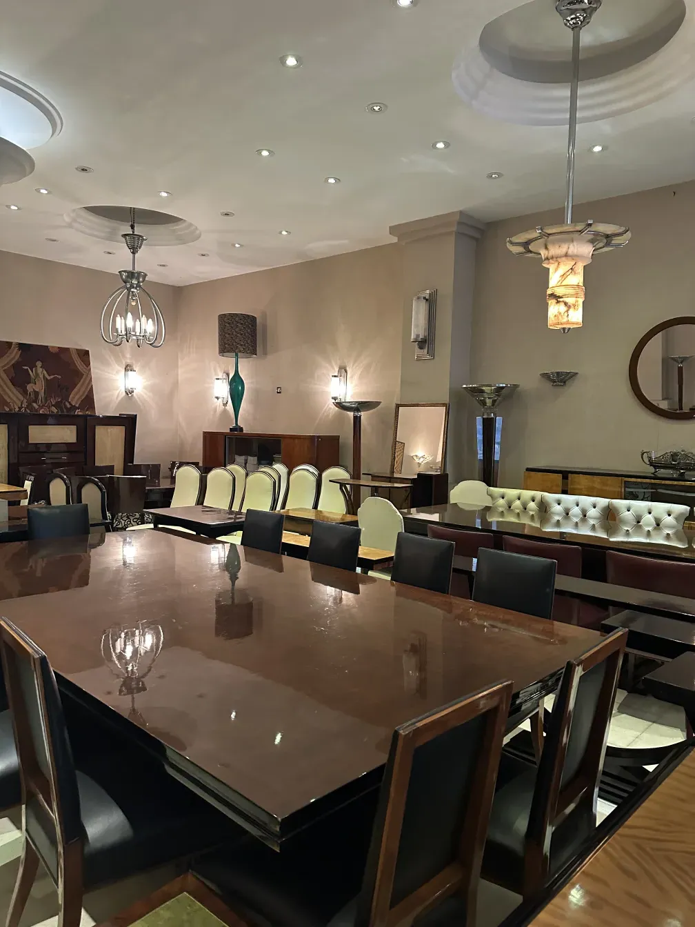 mesa de jantar antiga para 14 pessoas, ambiente elegante com cadeiras e lâmpadas