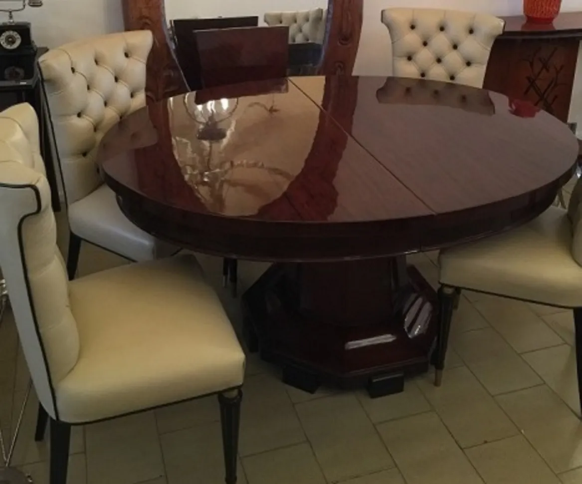 Antique round dining table with light leather chairs