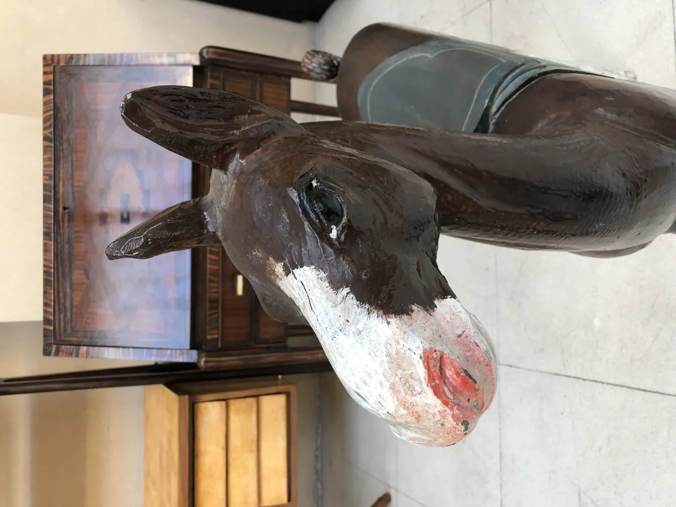 Antique decorative llama with painted details and elegant background.