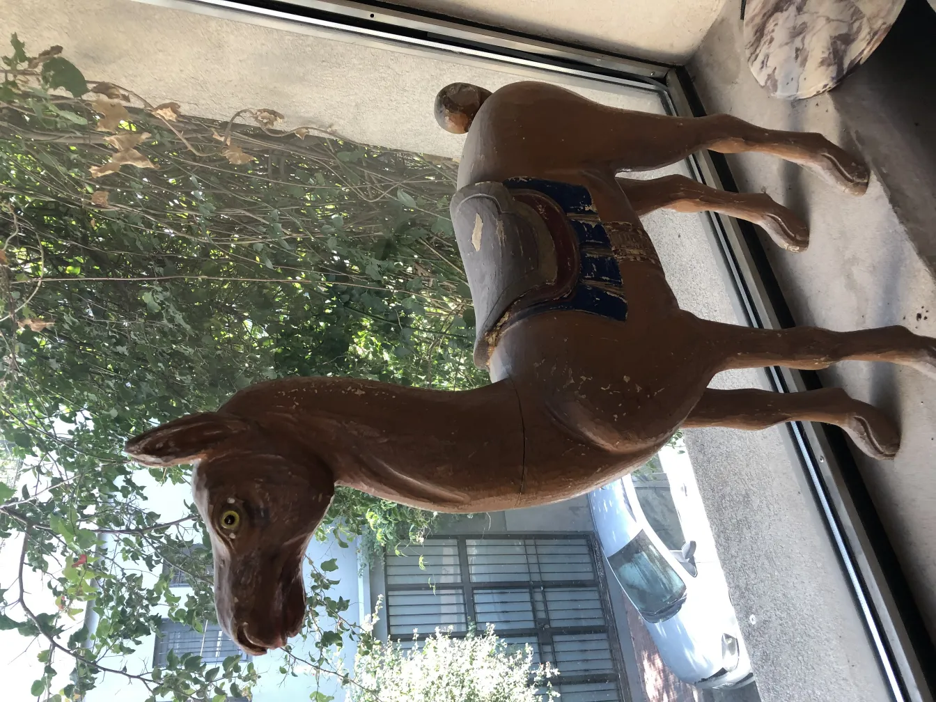 Antique decorative llama in a friendly setting.