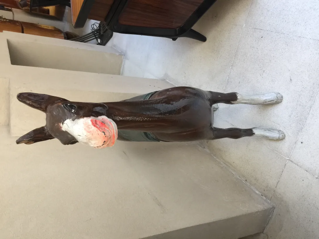 Antique llama sculpture, decorative, brown color, neutral background.