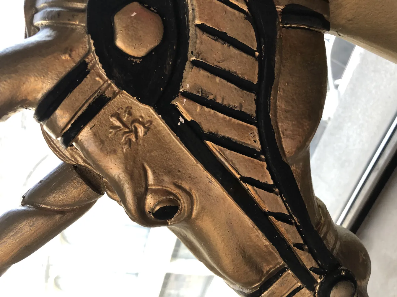 antique golden unicorn with black details