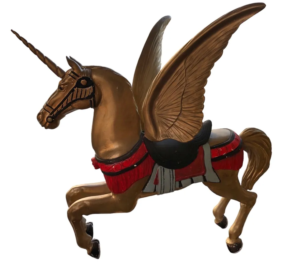 Vintage figurine of a winged unicorn in golden tones.