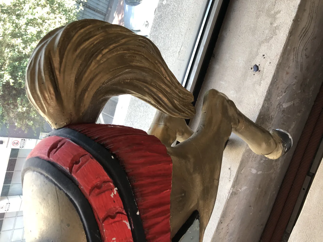 antique unicorn sculpture with golden mane and red adornments