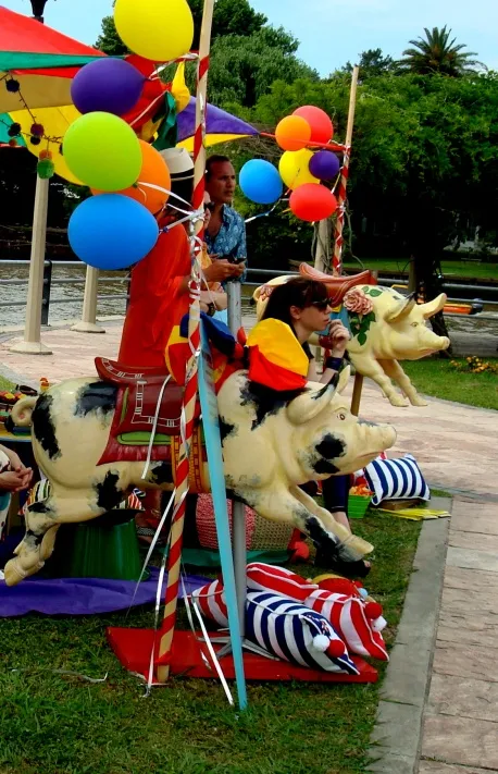 Antique pig toy decorated with bright colors in a festive setting.