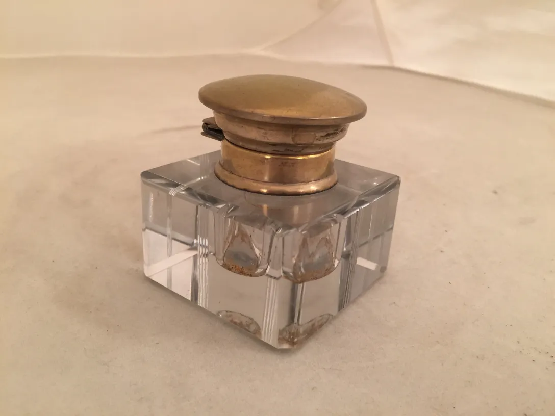 Antique square inkwell with a golden lid and elegant design