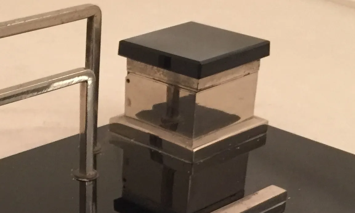 antique inkwell, sleek black lid, transparent body