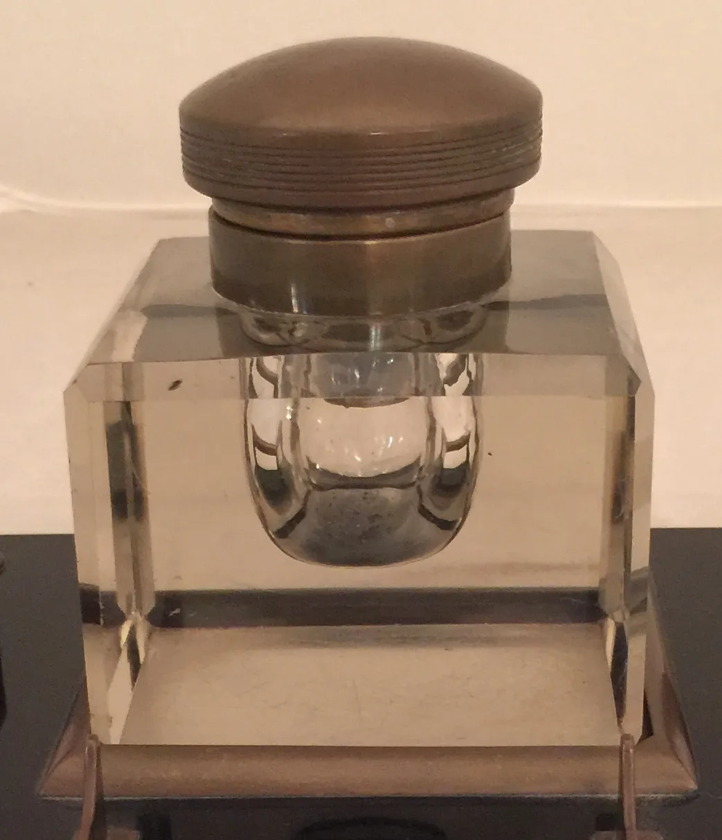 antique inkwell with round lid and elegant design