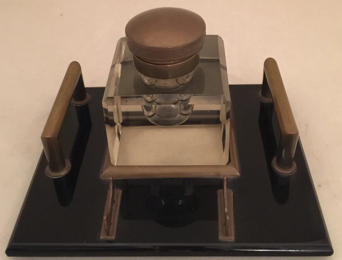 Antique inkwell with lid, elegant shape and details.