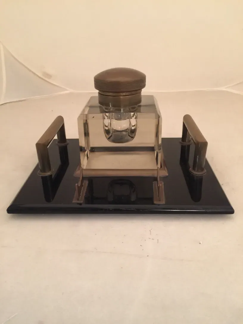 antique glass inkwell with elegant features, on black base