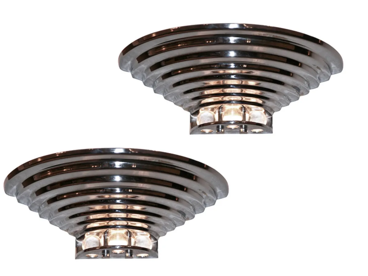 Pair of antique sconces with contemporary design in a modern setting.