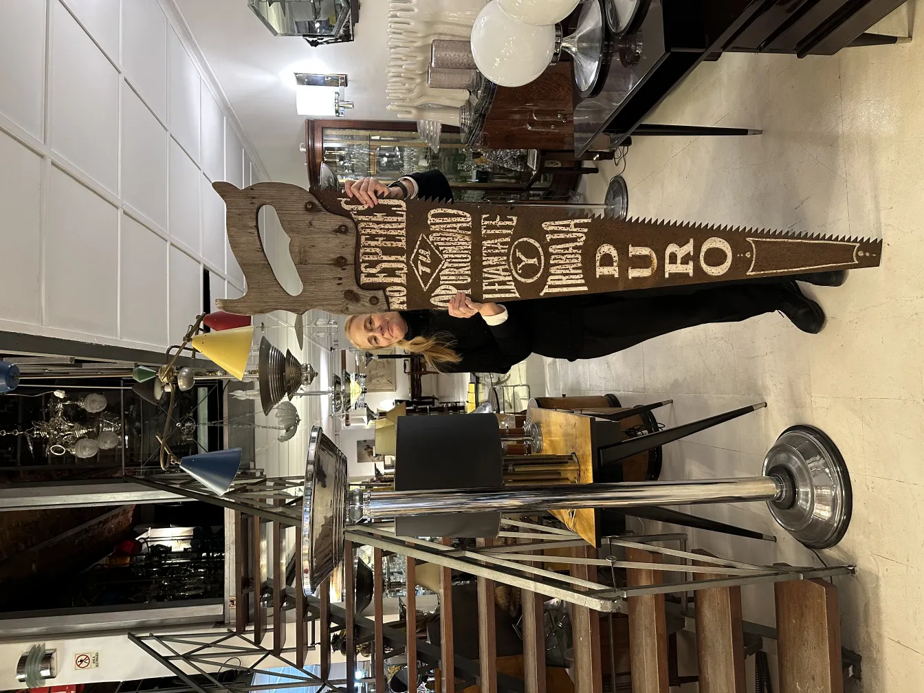 Antique advertising hand saw in a modern environment with vintage decorative details.