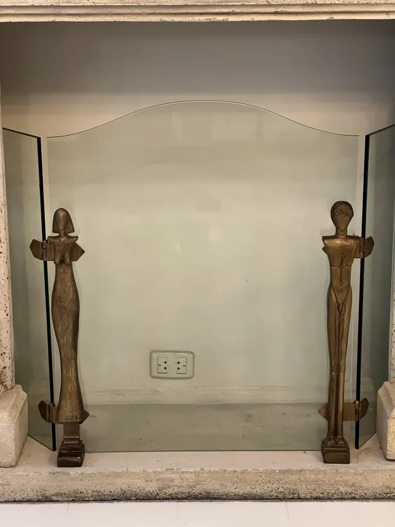 Antique fireplace front featuring Alberto Giacometti figures.