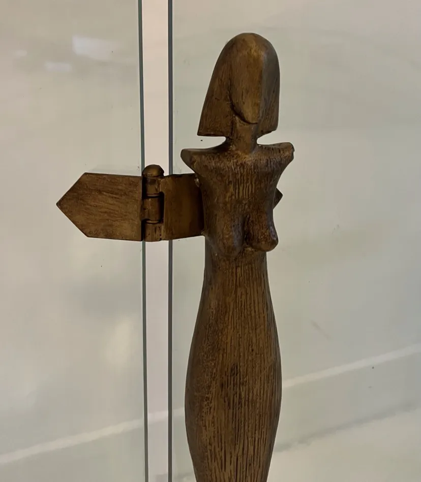 antique fireplace front featuring a sculpted female figure by Alberto Giacometti, displayed in a contemporary setting