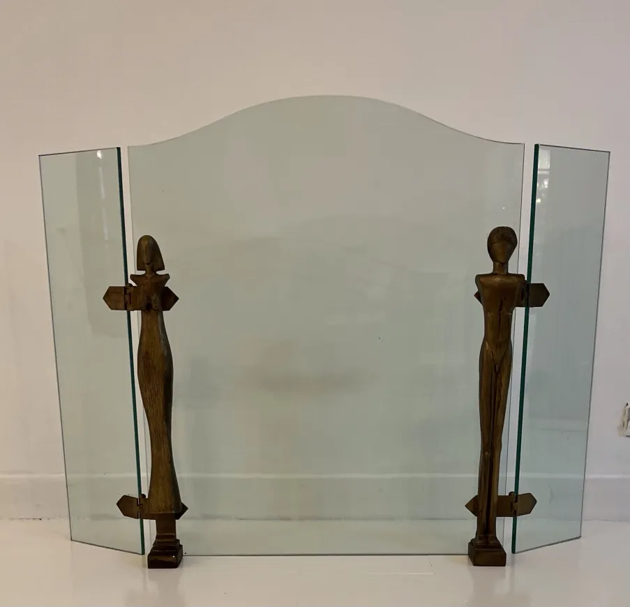 Antique fireplace front featuring stylized figures by Alberto Giacometti in an elegant setting.