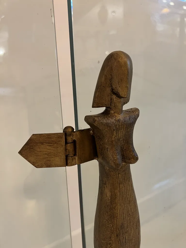 Façade de cheminée ancienne d'Alberto Giacometti avec des formes stylisées, exposée dans un cadre moderne.