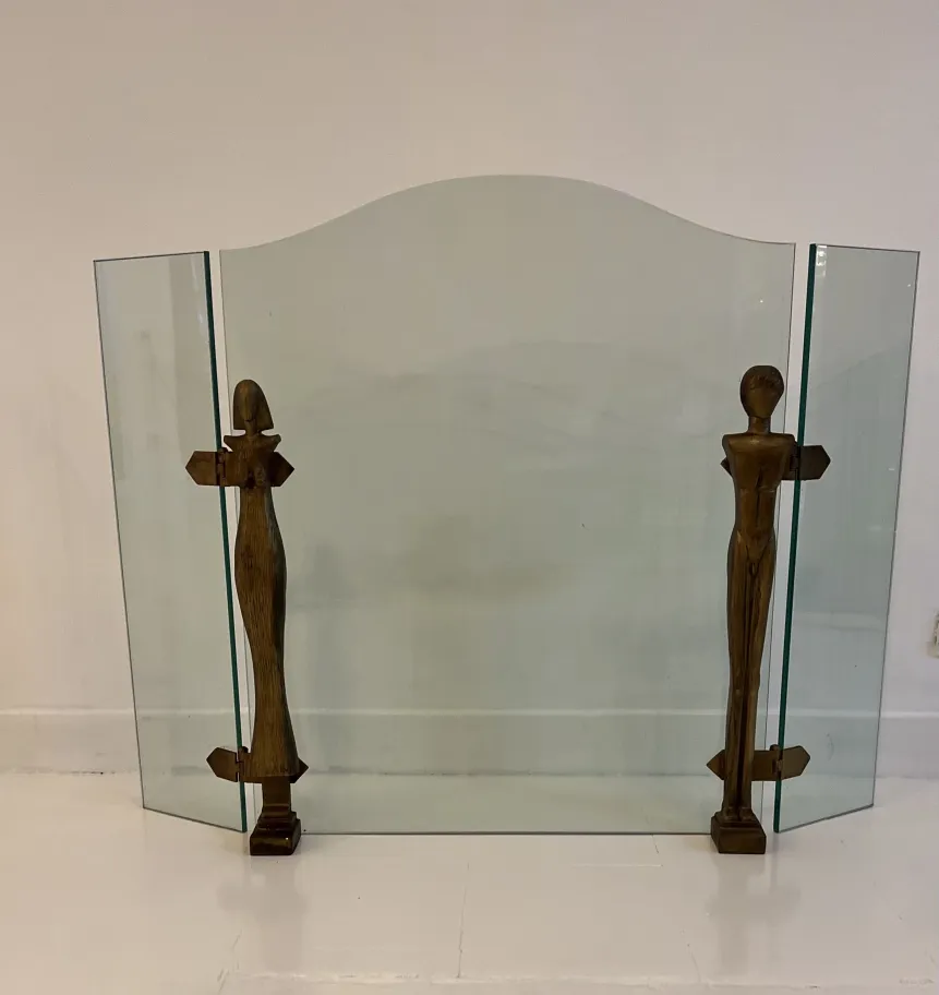 antique fireplace front featuring sculptural details and wooden figures, neutral background