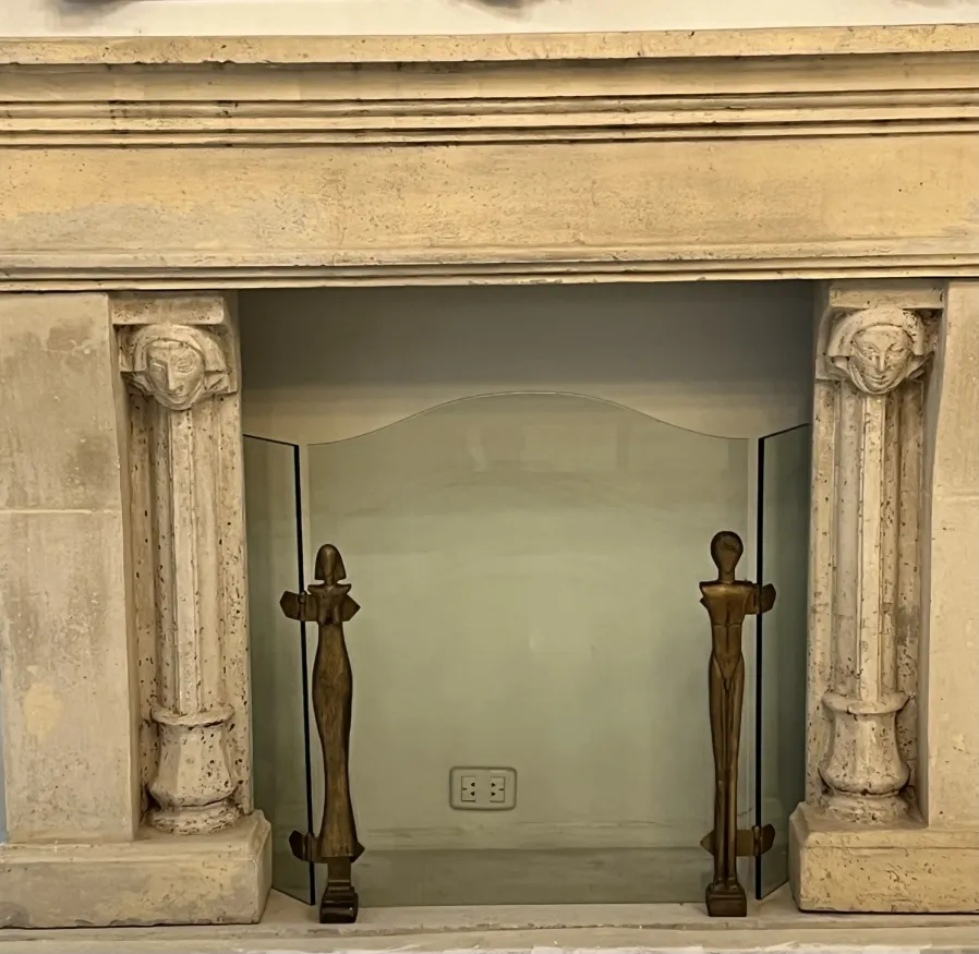 Cornice del camino antica con figure alla base.