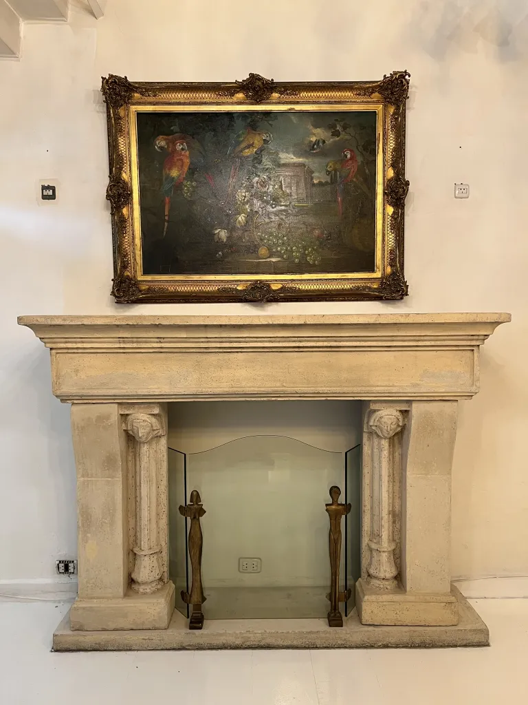 antique fireplace front with a decorative painting