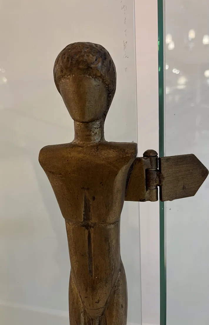 antique fireplace front, sculptural figure, Alberto Giacometti, in decorative setting