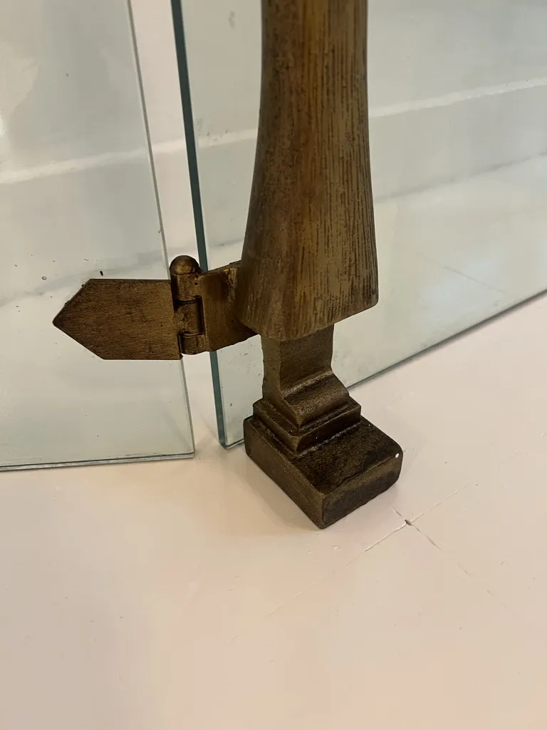 detail of an antique fireplace front by Alberto Giacometti with metal holder