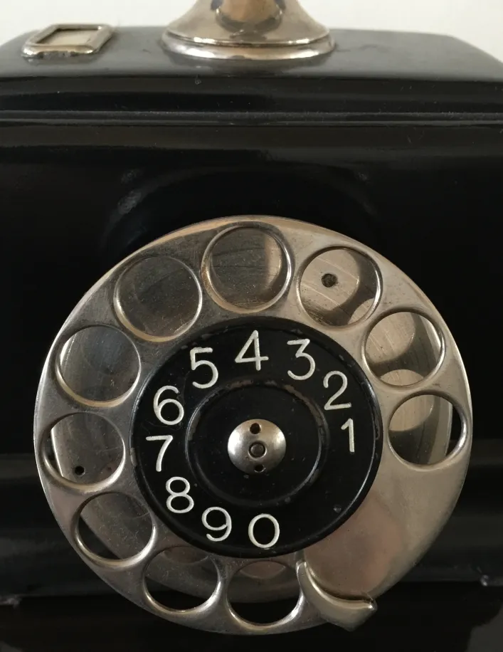 Antique phone with dial, dark background