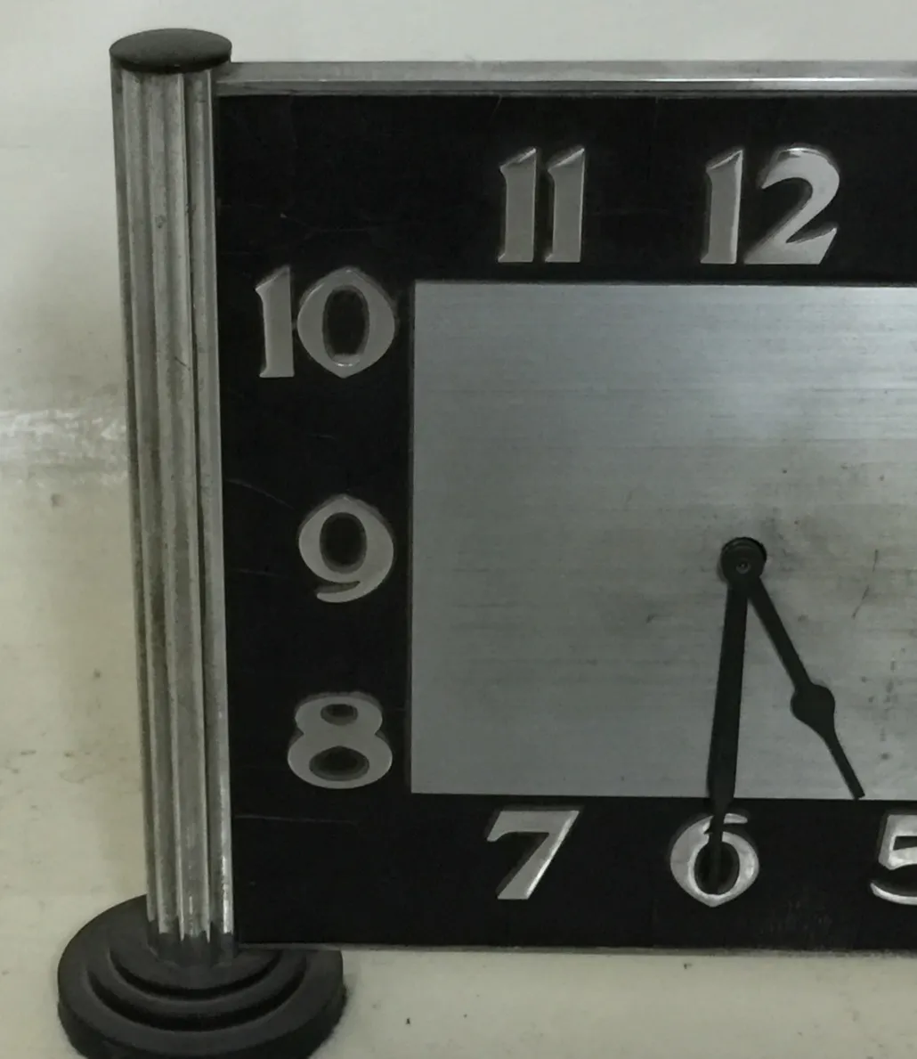 Antique table clock with classic design and large numbers.