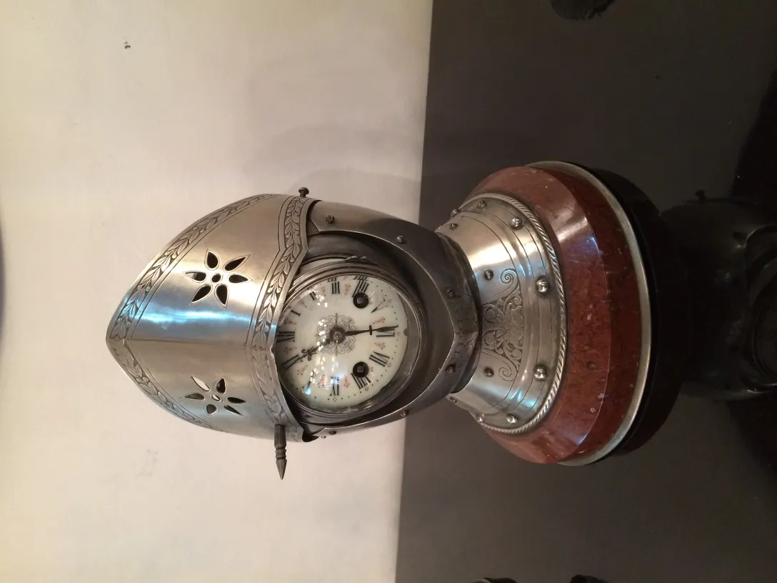 Antique garniture featuring decorative clock and candelabras.