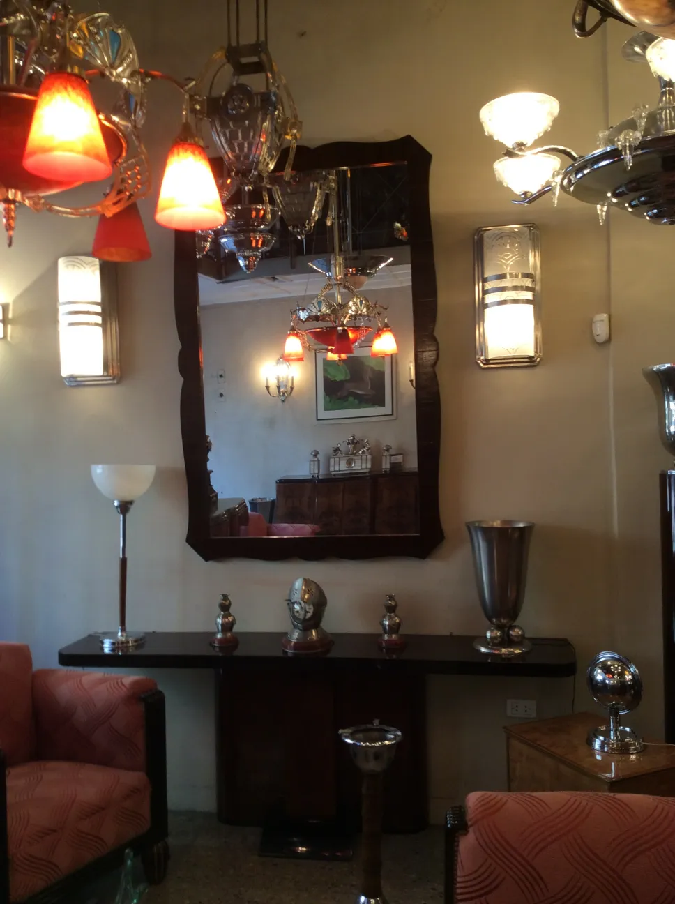 garniture featuring clock, 2 candelabras and a mirror in vintage setting