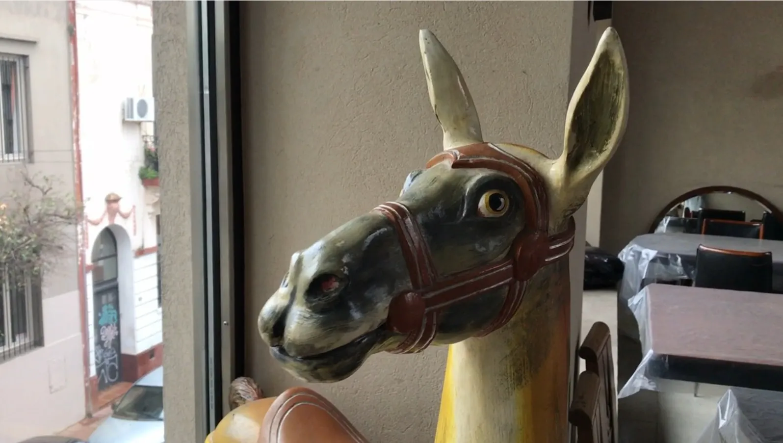 Antique decorative llama statue with vibrant colors.