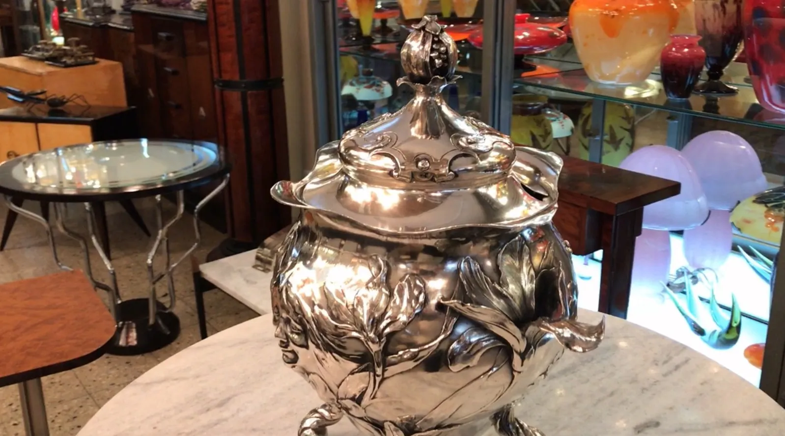 Antique WMF punch bowl with decorative details and elegant shape in an antique setting.