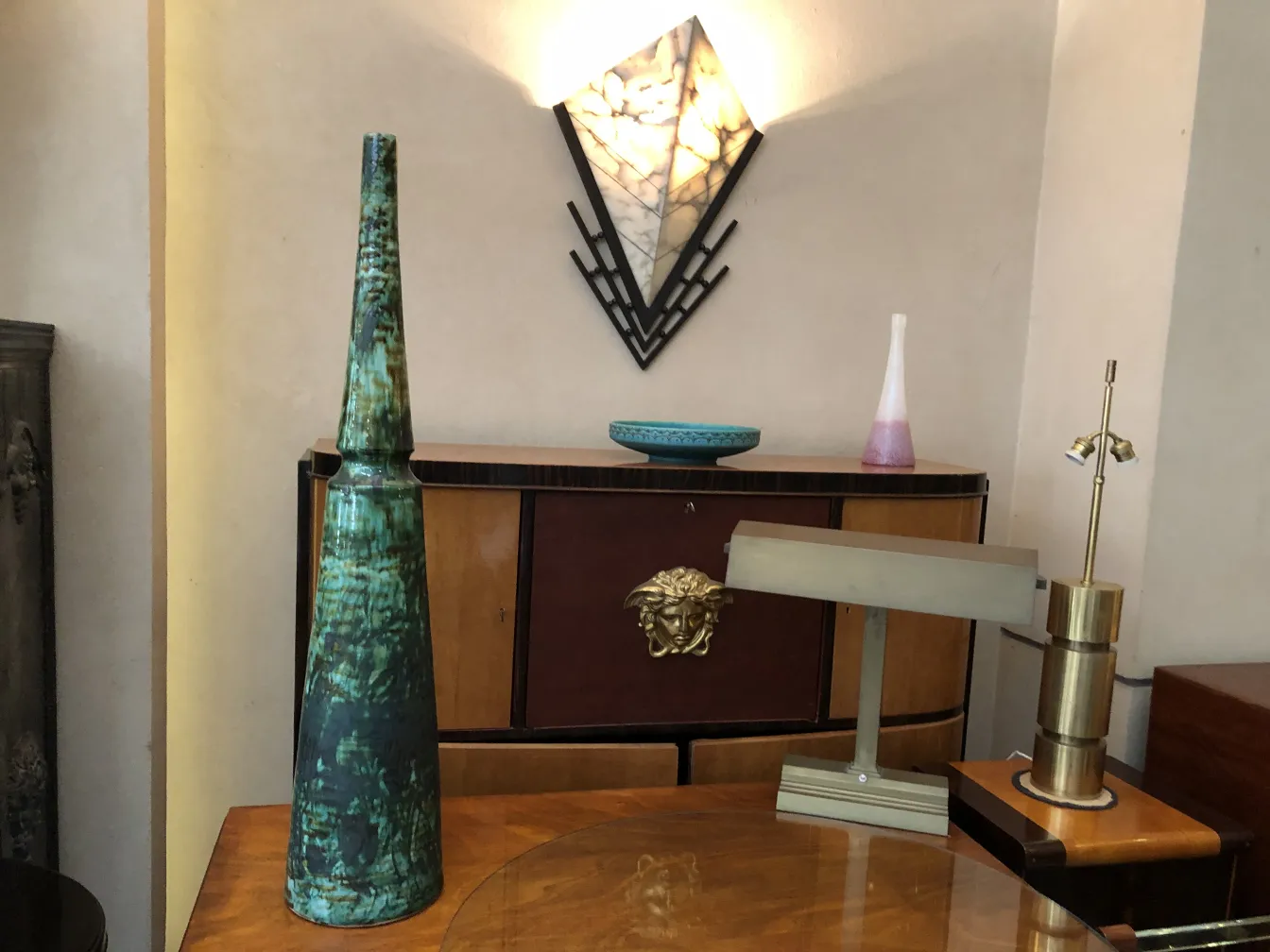 florero antiguo verde alto con detalles únicos en un entorno elegante